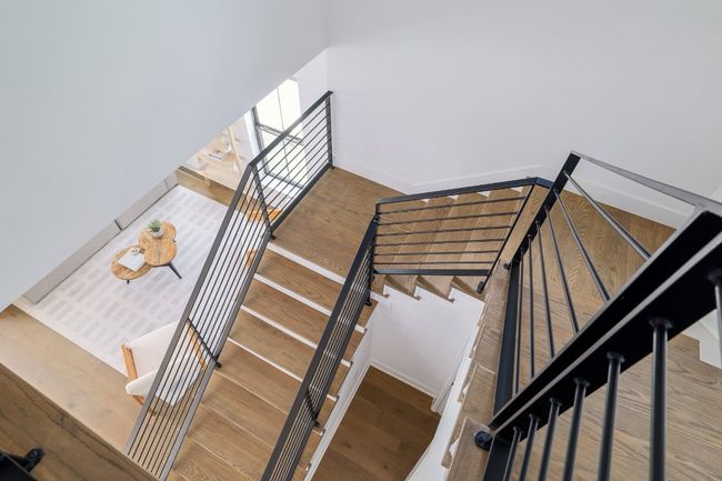 Staircase featuring wood finished floors and steel railing | Image 12