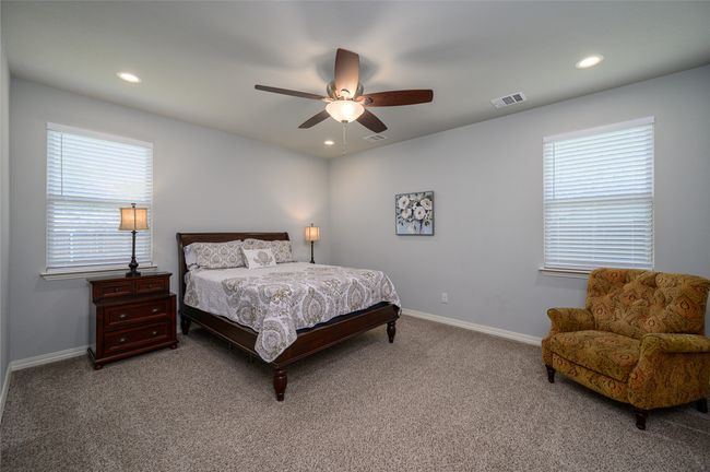 Master Bedroom featuring ensuite bathroom, multiple windows, ceiling fan, walk-in closet | Image 6