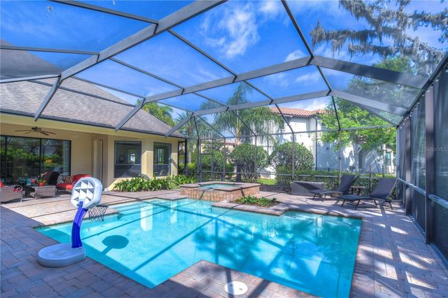 Dive into paradise with this spacious screened-in pool area, perfect for lazy afternoons and weekend gatherings. | Image 34