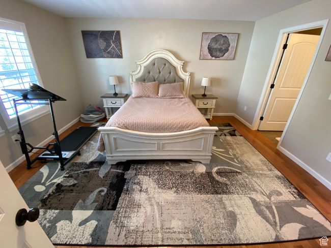 Bedroom featuring wood finished floors and baseboards | Image 14