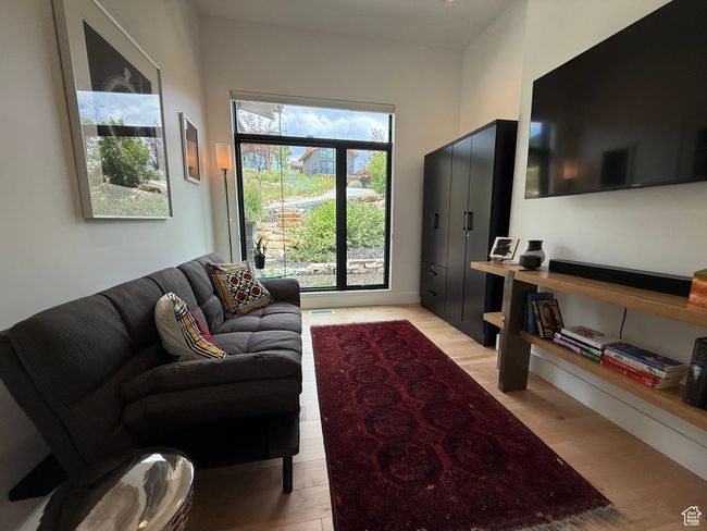 Living area featuring light wood-style flooring | Image 41