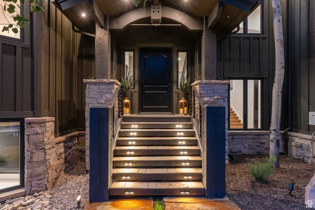 Entrance to property with board and batten siding and stone siding | Image 11