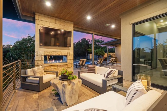 View of patio / terrace featuring an outdoor living space with a fireplace | Image 30