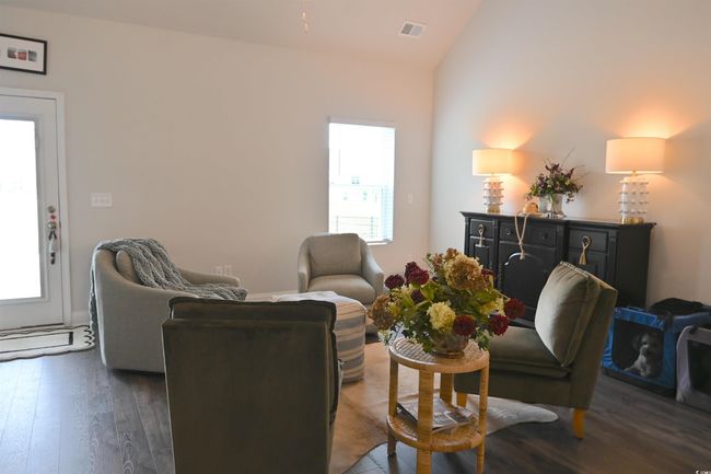 Living room with vaulted ceiling and dark wood-style floors | Image 11