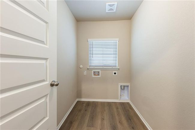 Washroom with hookup for an electric dryer, washer hookup, dark wood-style floors, and baseboards | Image 17