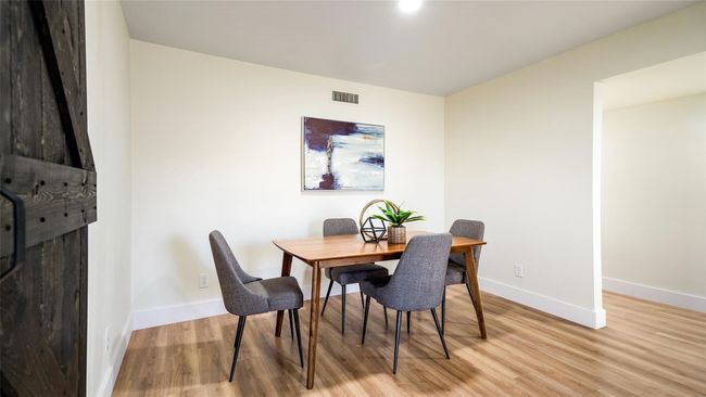 Dining room with visible vents, baseboards, and light wood-style flooring | Image 15