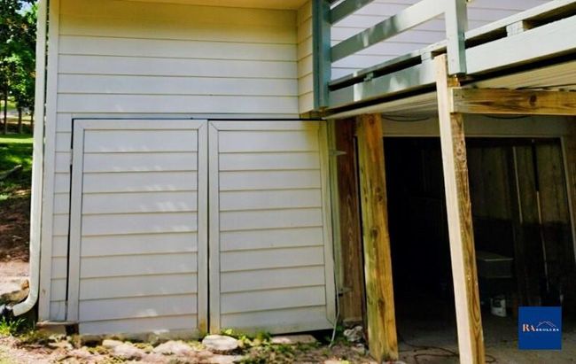 Spacious tandem garage for two cars, plus extra space perfect for golf cart parking. | Image 27