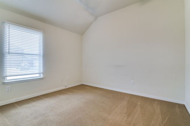 Carpeted guest bedroom featuring vaulted ceiling and baseboards | Image 18