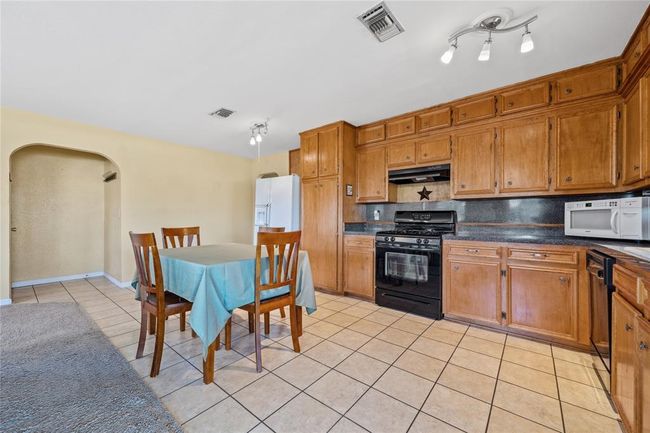 Beautiful kitchen cabinetry offer plenty of counter space and storage. | Image 10