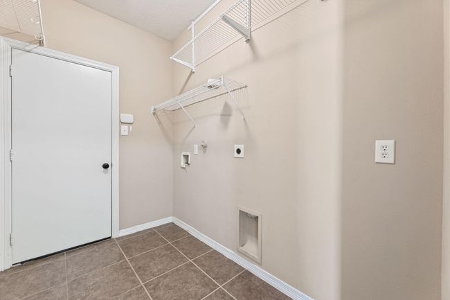 Utility room conveniently located in the house next to the 2-car garage. | Image 32