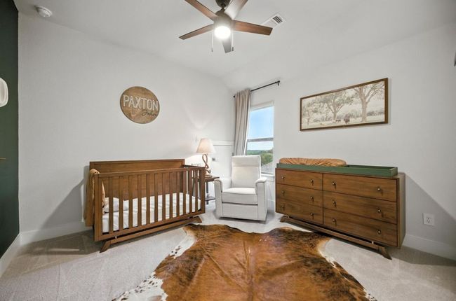 Upstairs Bedroom with vaulted ceiling, a crib, carpet flooring, and a ceiling fan | Image 30