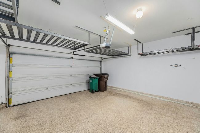 Garage with baseboards and a garage door opener | Image 22