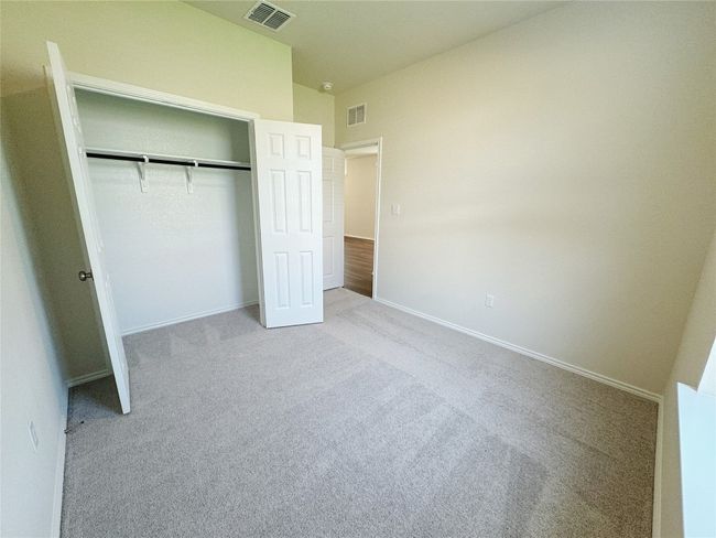 Unfurnished bedroom with carpet, a closet, and baseboards | Image 8