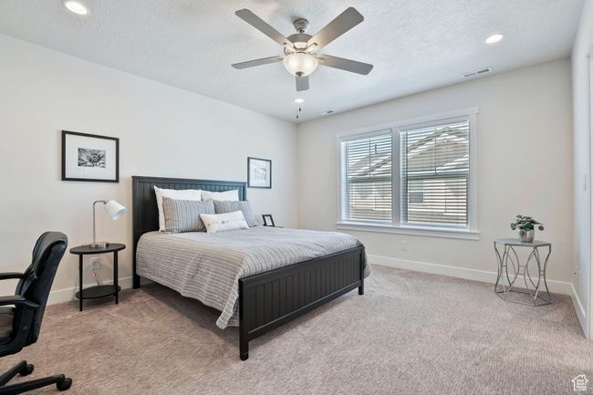 Bedroom with carpet floors, a textured ceiling, recessed lighting, and a ceiling fan | Image 13