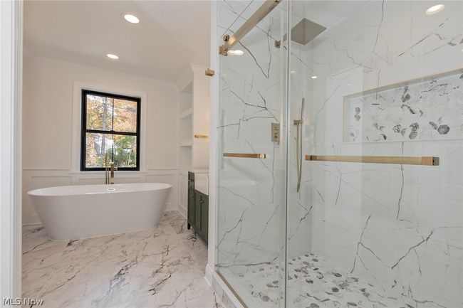 Bathroom with tile floors, plus walk in shower, tile walls, and vanity | Image 40