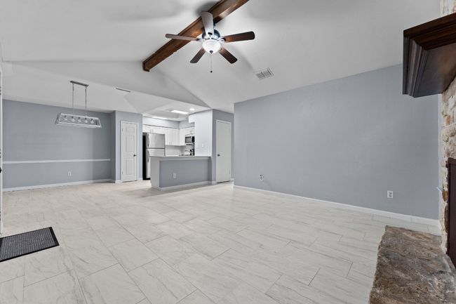 Unfurnished living room featuring ceiling fan | Image 19