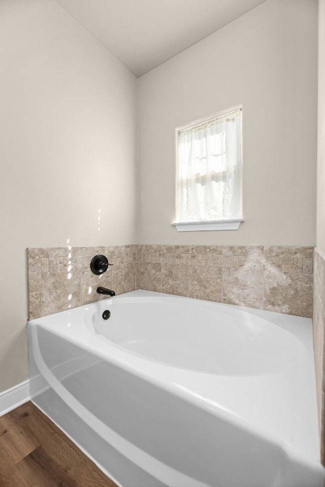 Bathroom with wood finished floors, baseboards, and a garden tub | Image 23