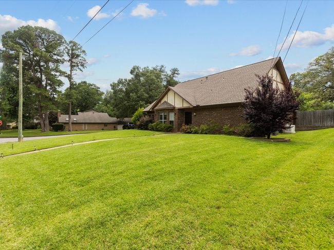 View of front of home featuring brick siding and roof with shingles | Image 5