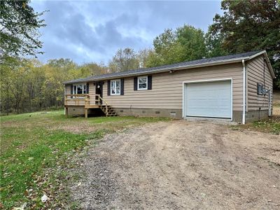 Manufactured / mobile home with a garage and a deck | Image 1