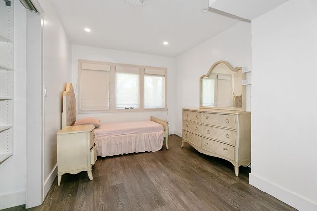 Bedroom featuring wood finished floors, recessed lighting, and baseboards | Image 19