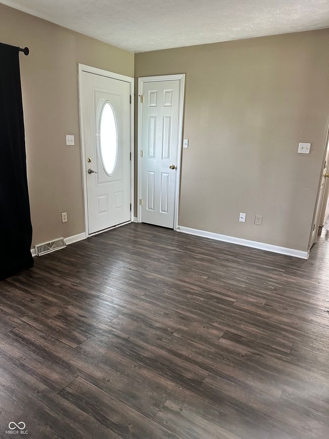 foyer with baseboards and dark wood finished floors | Image 4