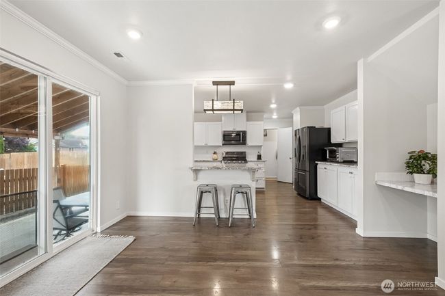 Eating area off of kitchen, and sliding door to large covered patio | Image 13