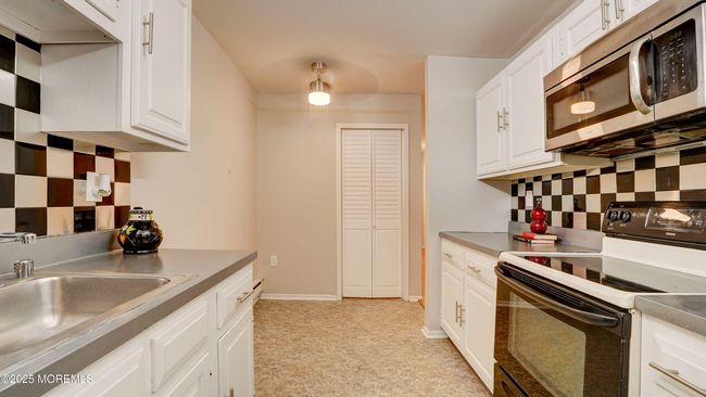 Eat in kitchen with adjacent laundry room. | Image 12