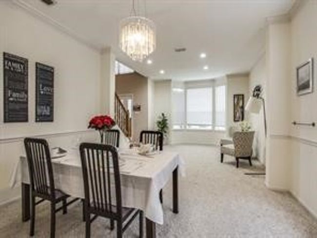 Dining room with stairway, a chandelier, recessed lighting, carpet, and ornamental molding | Image 14