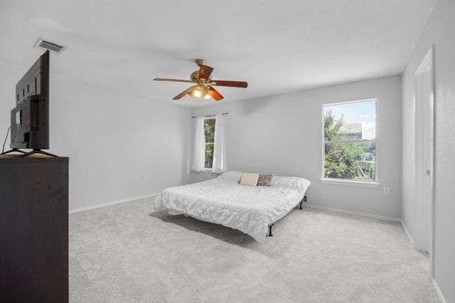 Primary bedroom upstairs includes a full bathroom and extra large walk-in closet. | Image 17