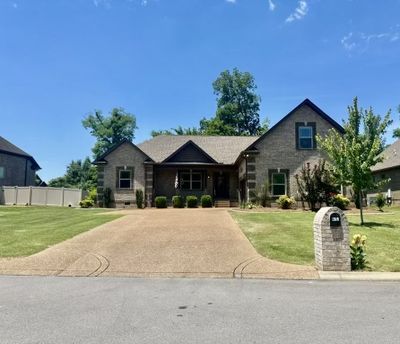 Primary Suite on main level; New hardwood in main living area & large Bonus Room. Granite countertops with custom cabinets and stainless steel appliances; Living Room has wood burning fireplace Private fenced backyard; Bring your boat! | Image 1