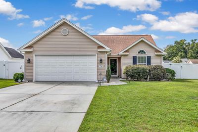 Ranch-style house with a garage and a front lawn | Image 3