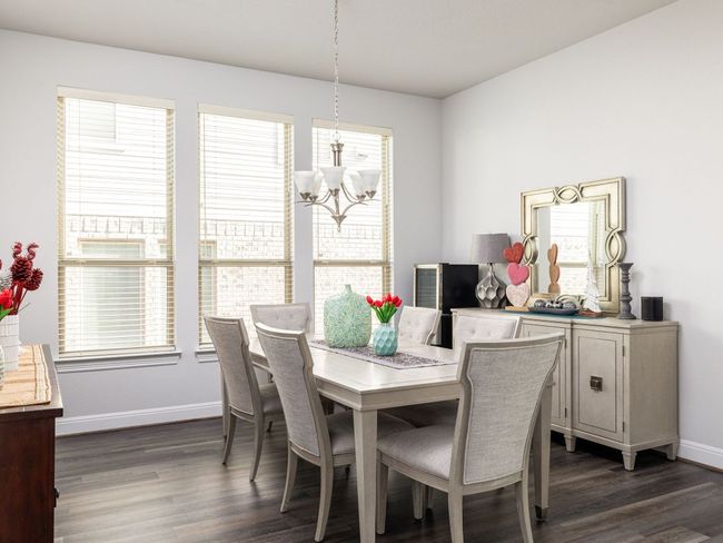 Dining room featuring baseboards, dark wood-style floors, and a notable chandelier | Image 12