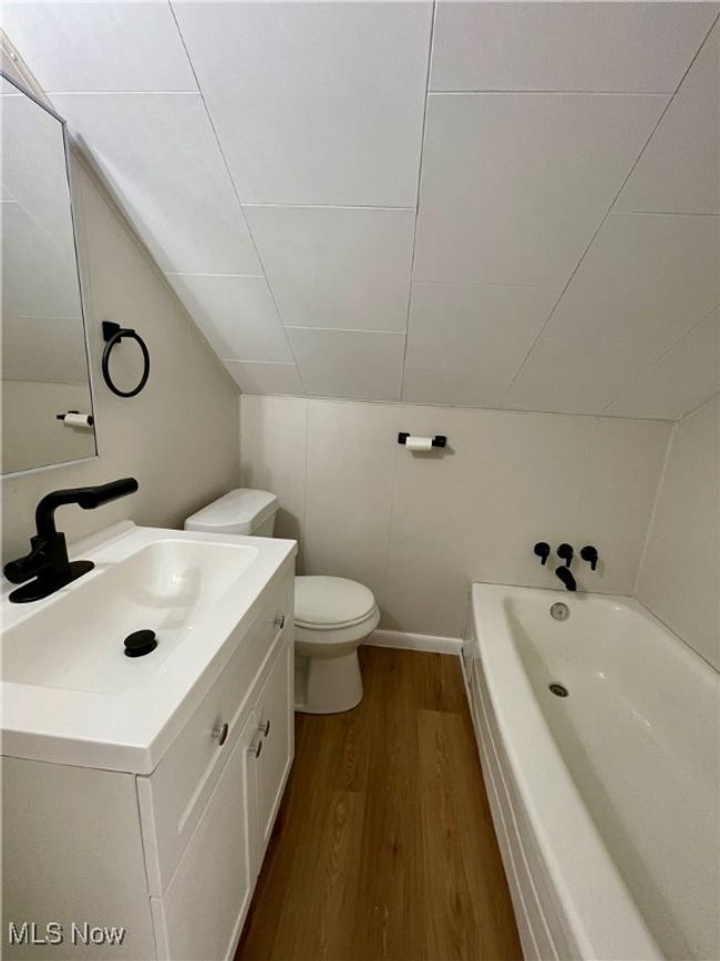 Full bath featuring wood finished floors, a tub, and vanity | Image 22