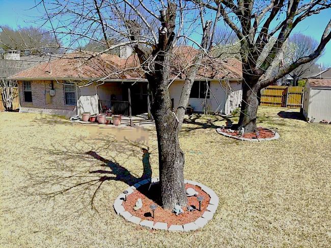 Back of property with a shingled roof and fence | Image 11