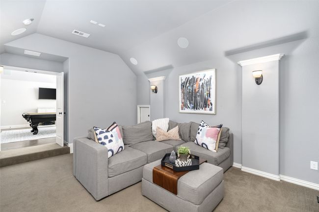 Theater room steps down for that movie night den feel and has french door entry. | Image 28