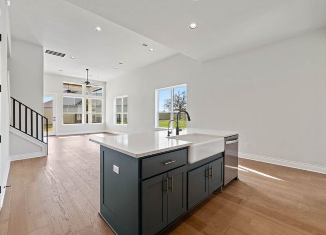 Kitchen with a sink, gray cabinetry, baseboards, dishwasher, and a ceiling fan | Image 14
