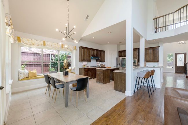 Dining area with a chandelier, plenty of natural light, high vaulted ceiling, recessed lighting, and light wood finished floors | Image 11
