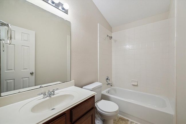 The second full bathroom is tastefully designed with modern fixtures and a combination tub/shower, serving the additional bedrooms. | Image 20