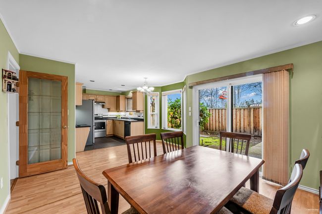 Dining space with light wood-style floors, a notable chandelier, ornamental molding, and recessed lighting | Image 8