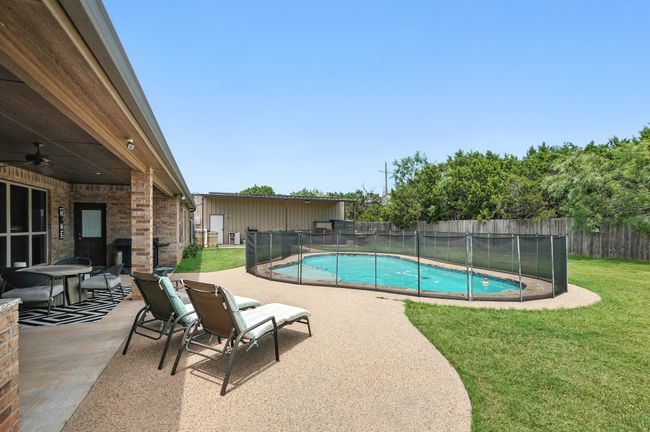 View of pool featuring ceiling fan, a fenced backyard, and a patio area | Image 31