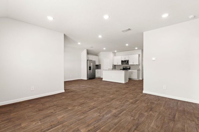 Living room featuring recessed lighting, dark vinyl wood-style floors, and baseboards | Image 6