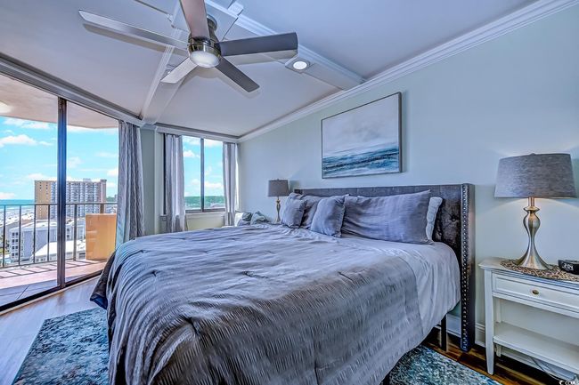 Bedroom with hardwood / wood-style floors, ceiling fan, access to outside, and ornamental molding | Image 17
