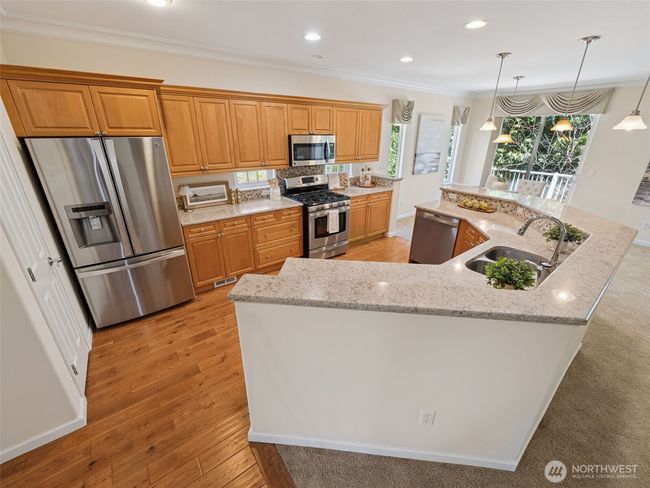 Chef's kitchen features side by side fridge, an abundance of cabinets and plenty of counter space for you and your company! | Image 6