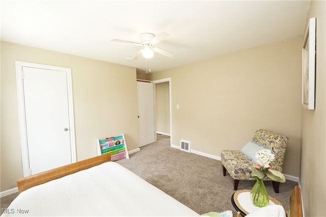 Bedroom featuring carpet floors, visible vents, a ceiling fan, and baseboards | Image 21