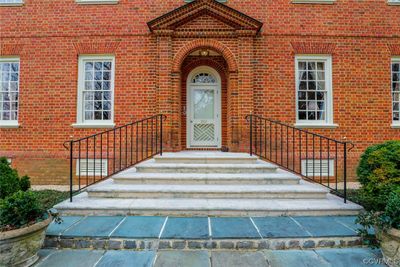 Built of Old Virginia Wood Molded Brick in the Flemish Bond pattern, the focal point of the front is the solid brick pediment and side pilaster set with recessed entryway. Period details include the flat segmented arches as window lintels, brick water course and French drain system. Front steps are aggregated stone and Pennsylvania Blue Stone. | Image 2