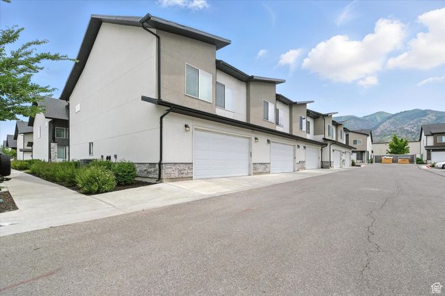 View of asphalt road featuring a mountain view and a residential view | Image 22