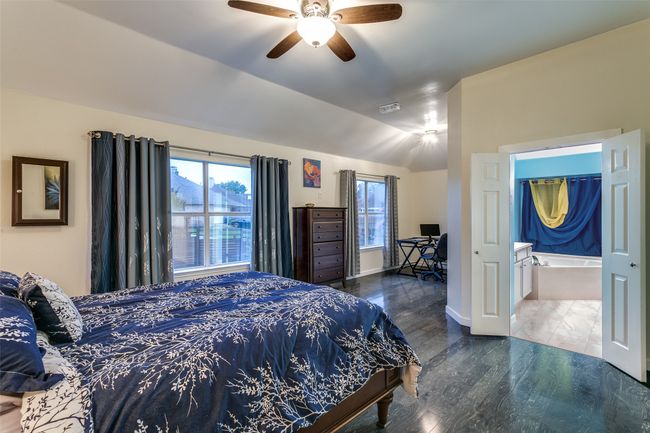 Bedroom featuring wood finished floors, baseboards, a ceiling fan, and lofted ceiling | Image 14