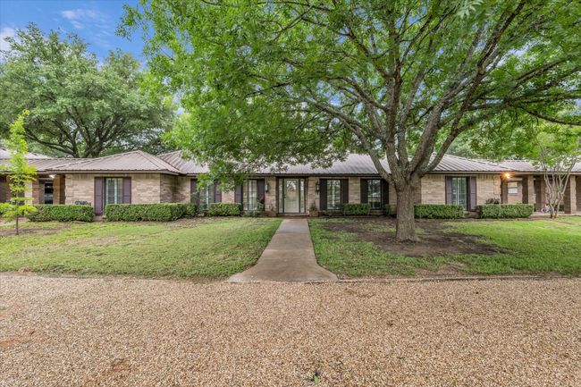 Ranch-style home with a metal roof and a front yard | Image 5