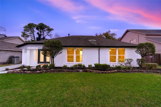 The home’s stunning front elevation showcases a timeless and modern look with its freshly painted white brick exterior. This classic yet contemporary update enhances the home’s curb appeal, giving it a clean, sophisticated aesthetic. | Image 27