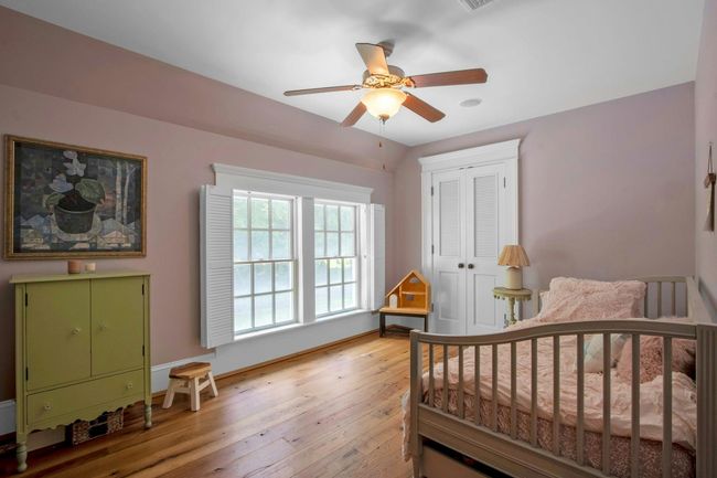 Bedroom featuring light wood-style floors, a closet, baseboards, and ceiling fan | Image 24